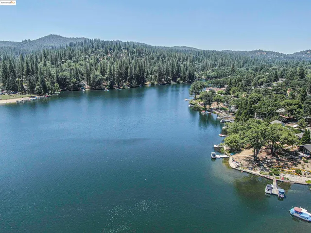 a view of a house with pool and a yard
