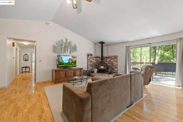 a living room with furniture floor to ceiling window and a fireplace