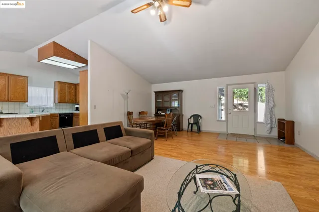 a room with dining table chairs and windows