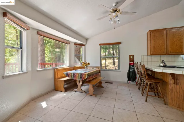 a kitchen with a table chairs refrigerator and cabinets