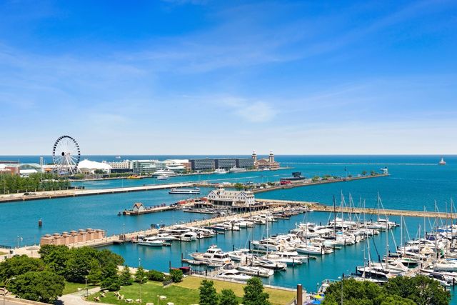 a room with lots of white furniture and a rug