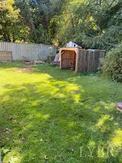 a view of a backyard with a tub and trees