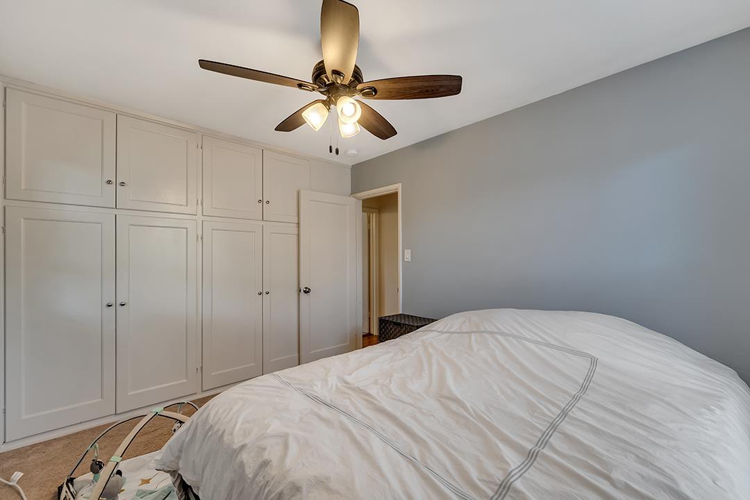 1197 Broadleaf Lane San Jose, CA 95128 - Photo 12 of 29 a bedroom with a bed and a chandelier