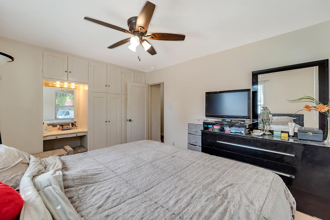 1197 Broadleaf Lane San Jose, CA 95128 - Photo 14 of 29 a bedroom with a bed and a flat screen tv