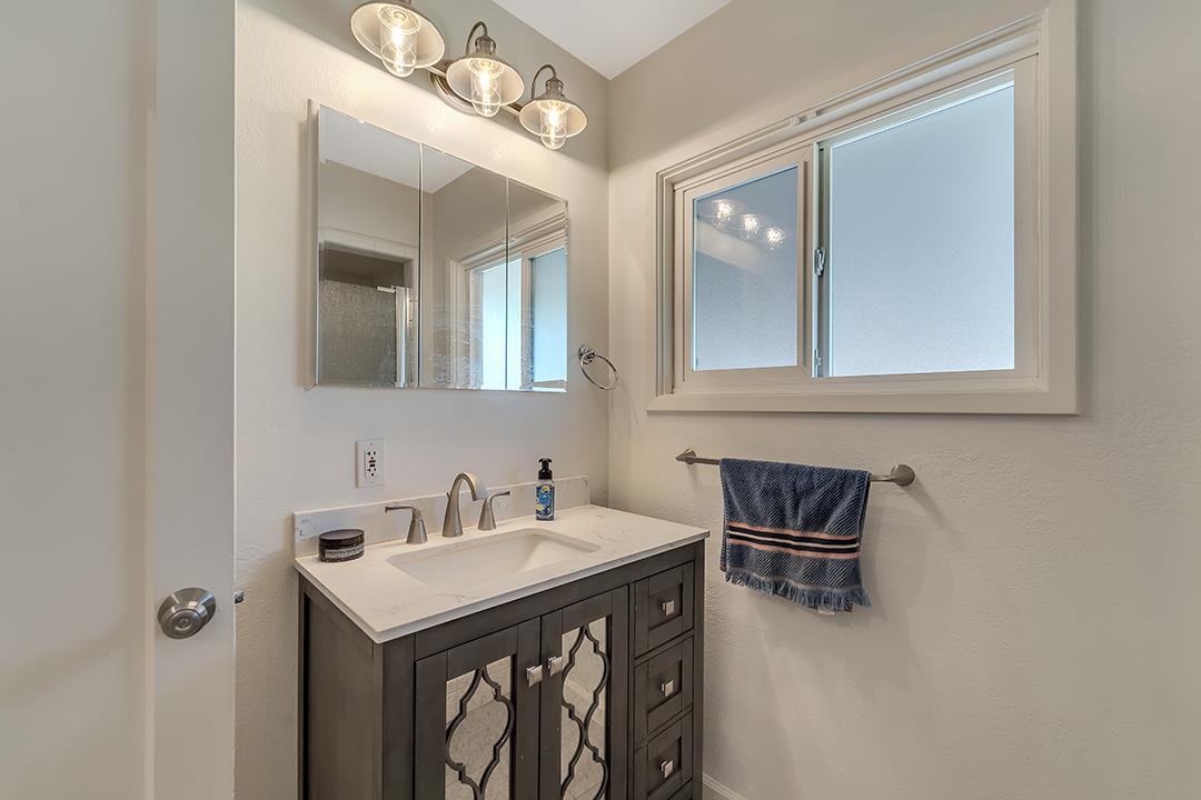 1197 Broadleaf Lane San Jose, CA 95128 - Photo 17 of 29 a bathroom with a sink and a mirror