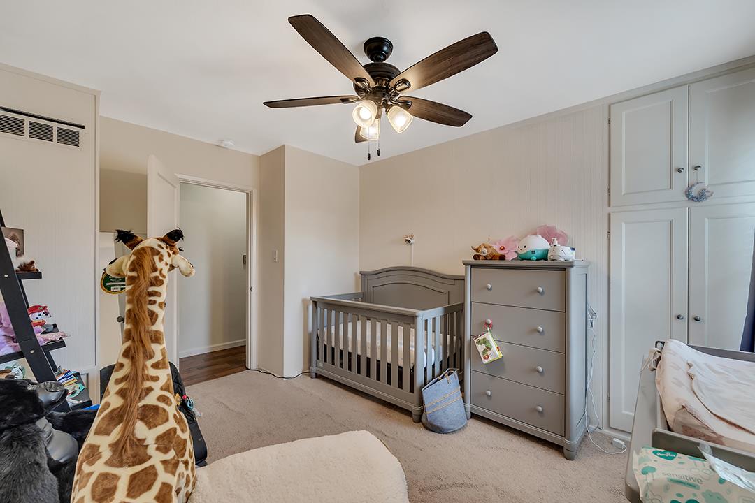 1197 Broadleaf Lane San Jose, CA 95128 - Photo 19 of 29 a bedroom with furniture and baby bed