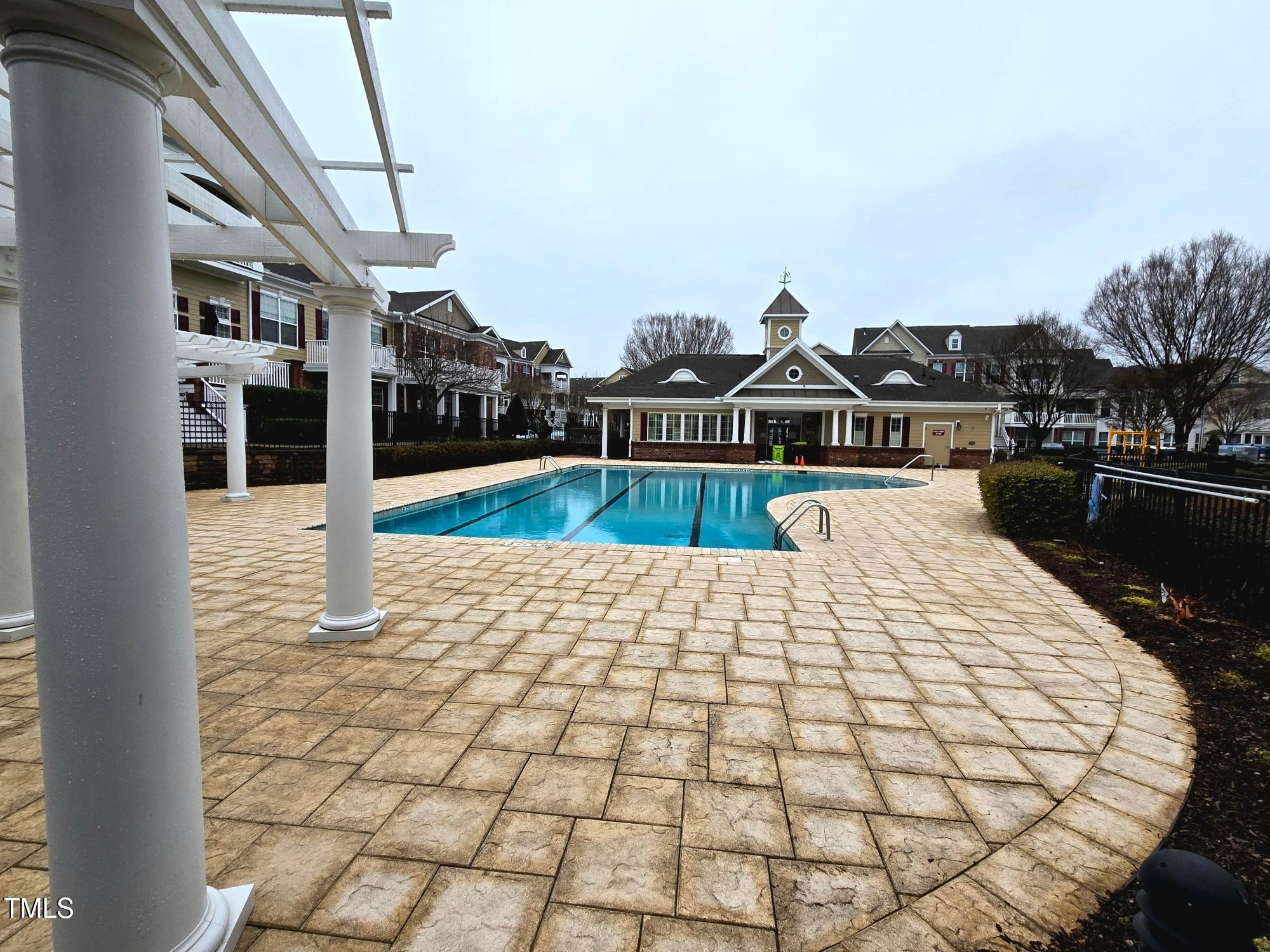 10420 Sablewood Drive, Unit 102 Raleigh, NC 27617 - Photo 14 of 15 a large white building with a swimming pool