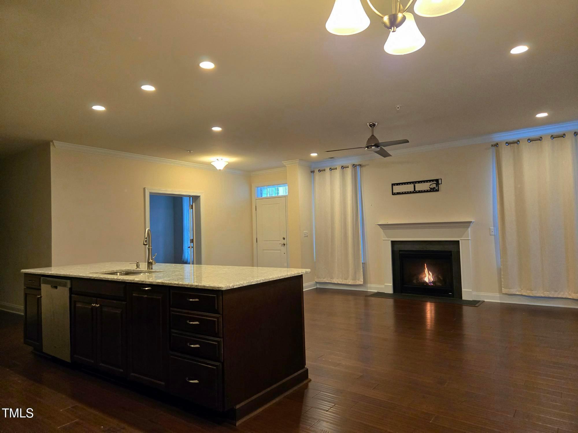 10420 Sablewood Drive, Unit 102 Raleigh, NC 27617 - Photo 6 of 15 a room with a chandelier and fireplace
