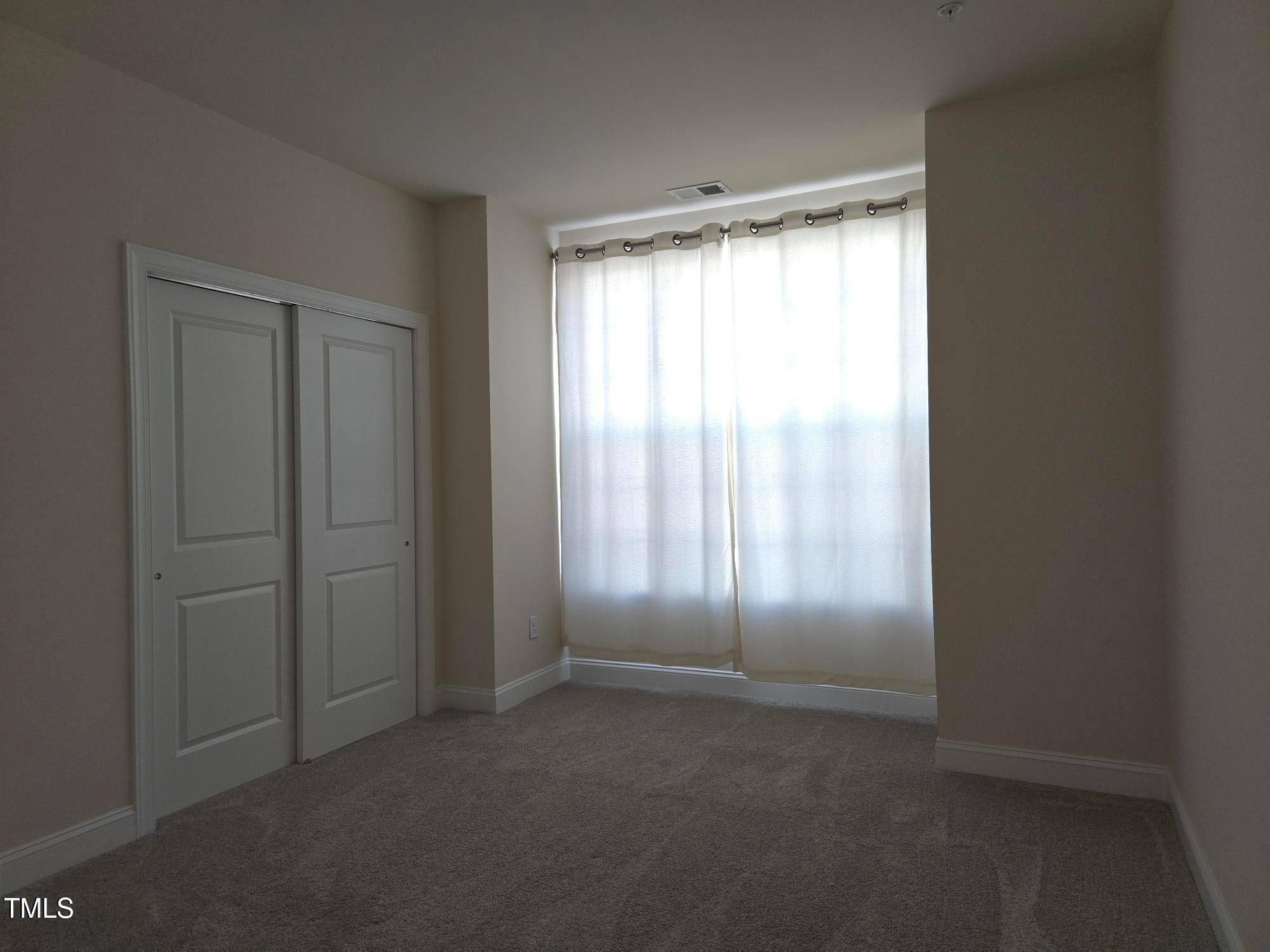 10420 Sablewood Drive, Unit 102 Raleigh, NC 27617 - Photo 9 of 15 a view of an empty room with a window