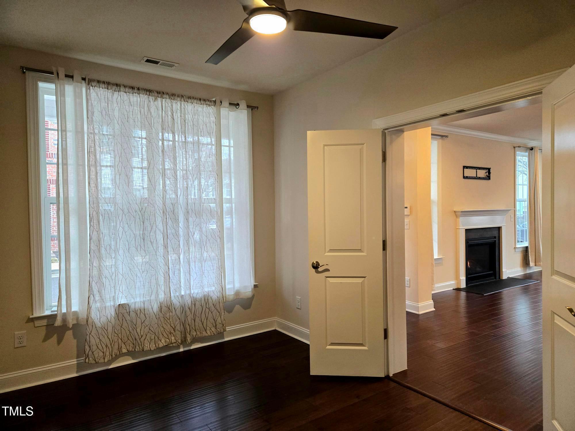 10420 Sablewood Drive, Unit 102 Raleigh, NC 27617 - Photo 10 of 15 wooden floor in an empty room with a window