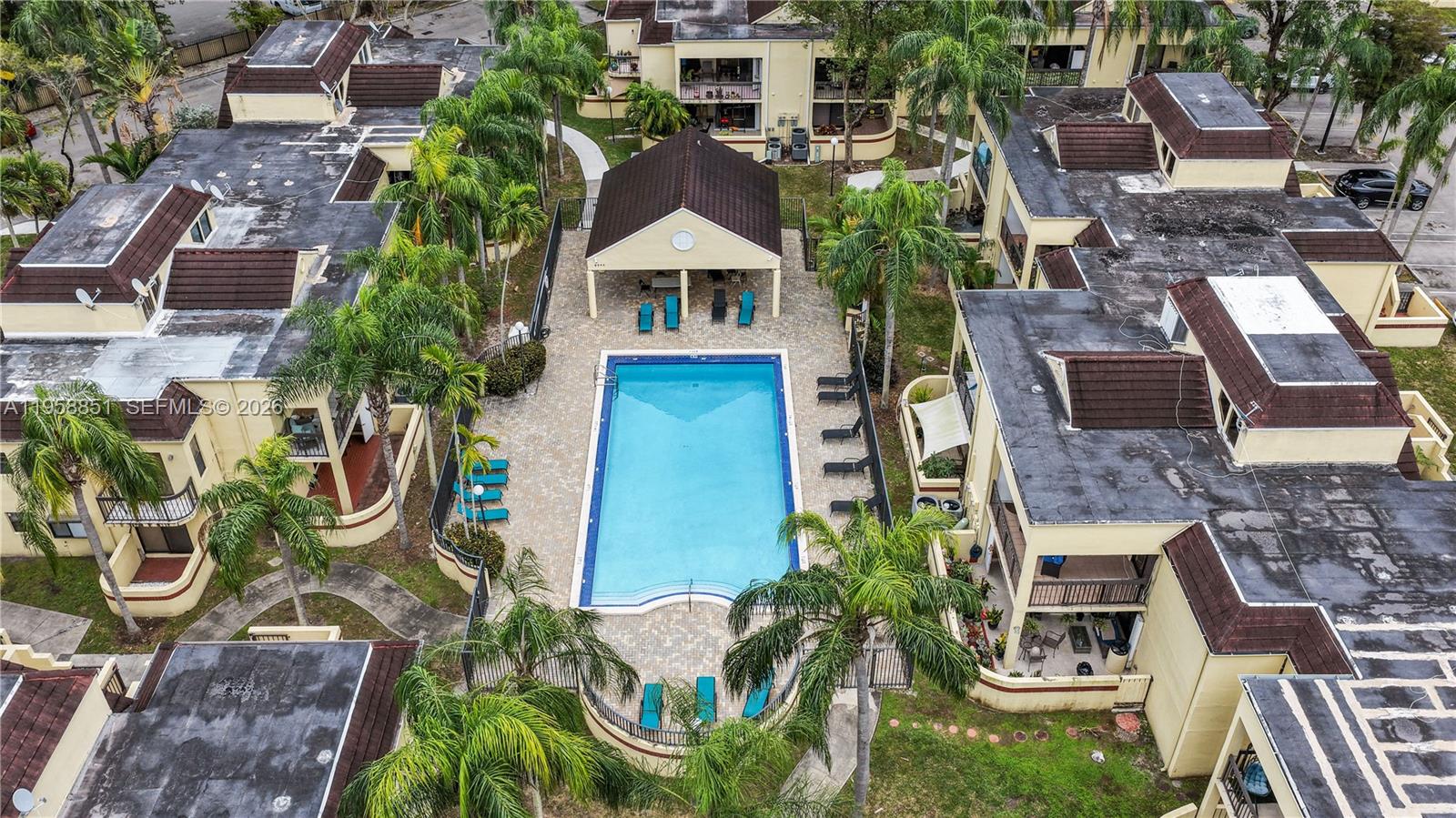 an aerial view of residential houses with outdoor space