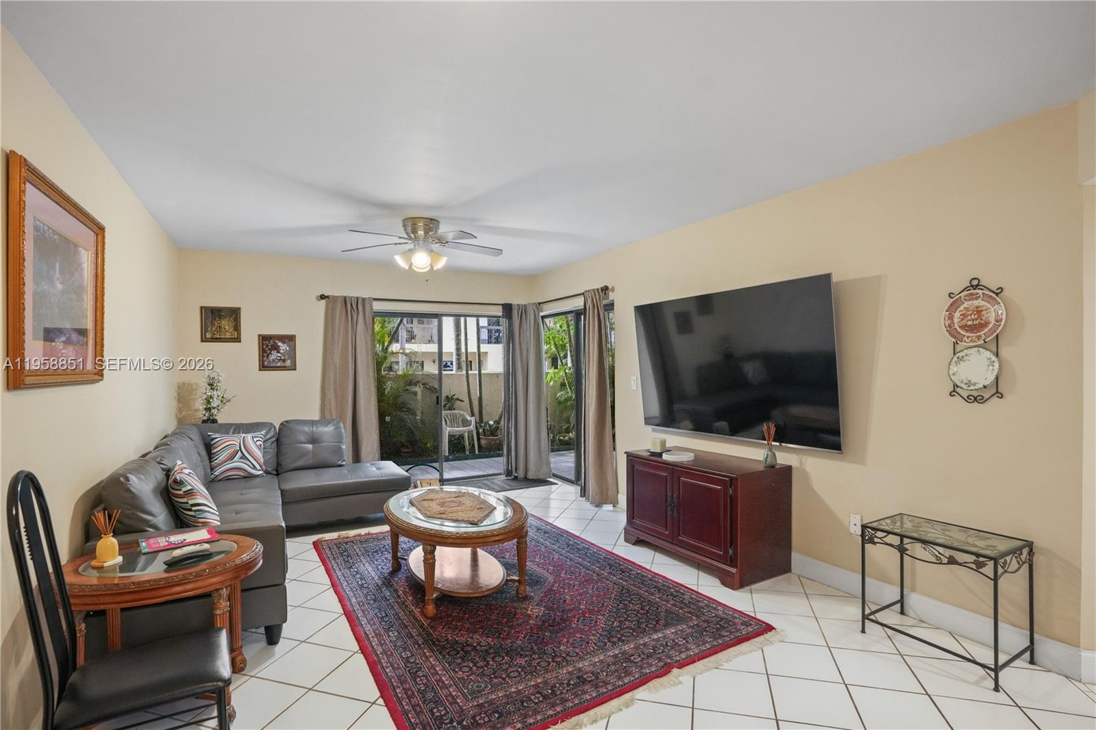 12930 Southwest 88th Terrace, Unit A104 Miami, FL 33186 - Photo 11 of 38 a living room with furniture and a flat screen tv