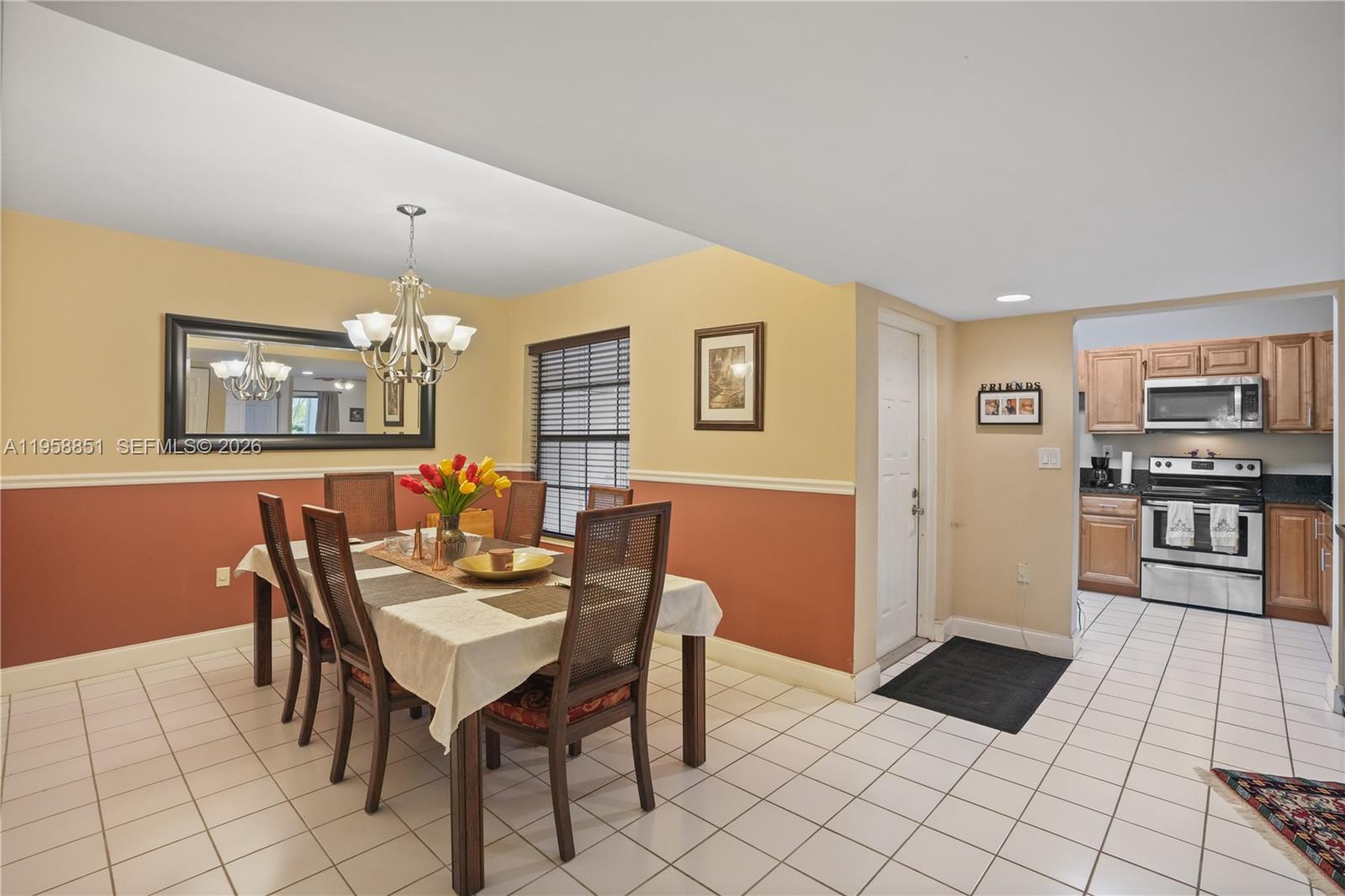 12930 Southwest 88th Terrace, Unit A104 Miami, FL 33186 - Photo 14 of 38 a view of a dining room with furniture