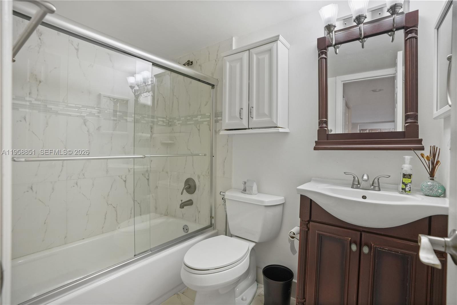 12930 Southwest 88th Terrace, Unit A104 Miami, FL 33186 - Photo 16 of 38 a bathroom with a sink toilet and shower