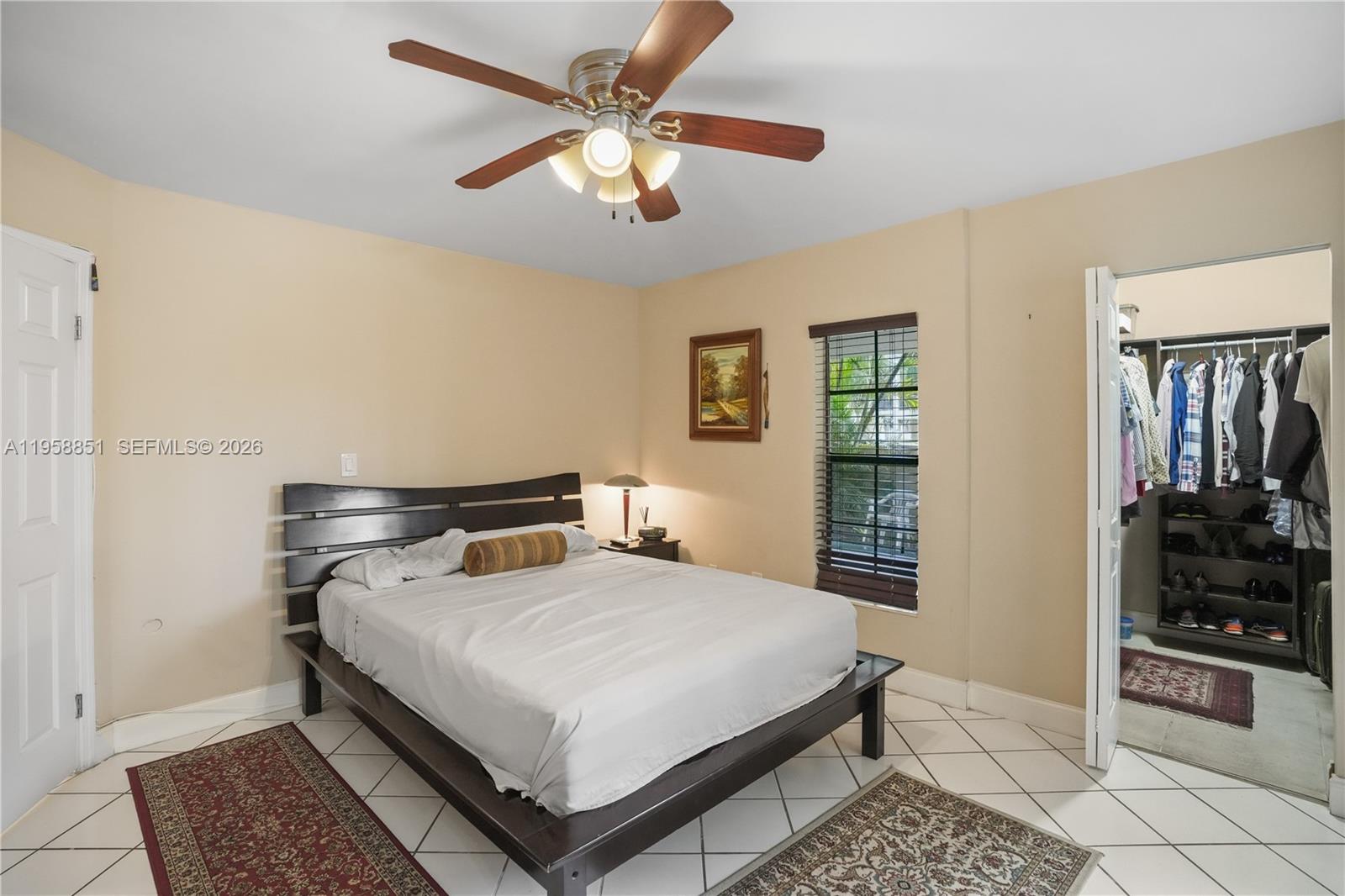 12930 Southwest 88th Terrace, Unit A104 Miami, FL 33186 - Photo 19 of 38 a bedroom with a bed and dresser