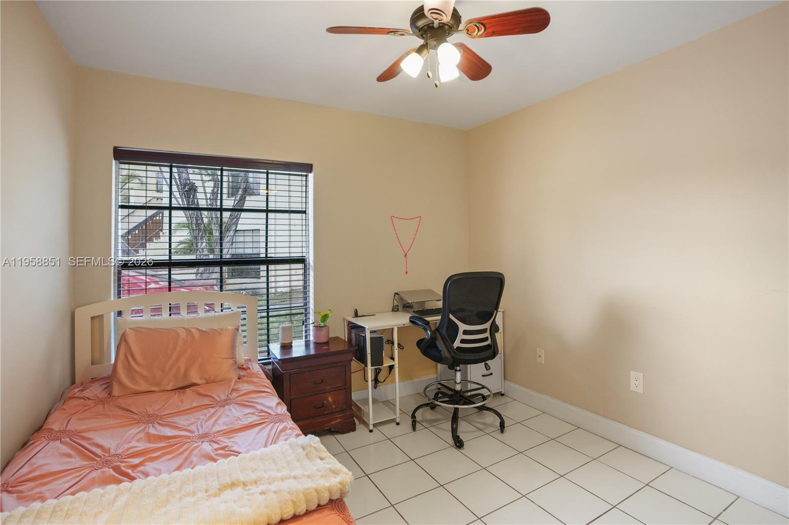 12930 Southwest 88th Terrace, Unit A104 Miami, FL 33186 - Photo 23 of 38 a bedroom with a bed and chair
