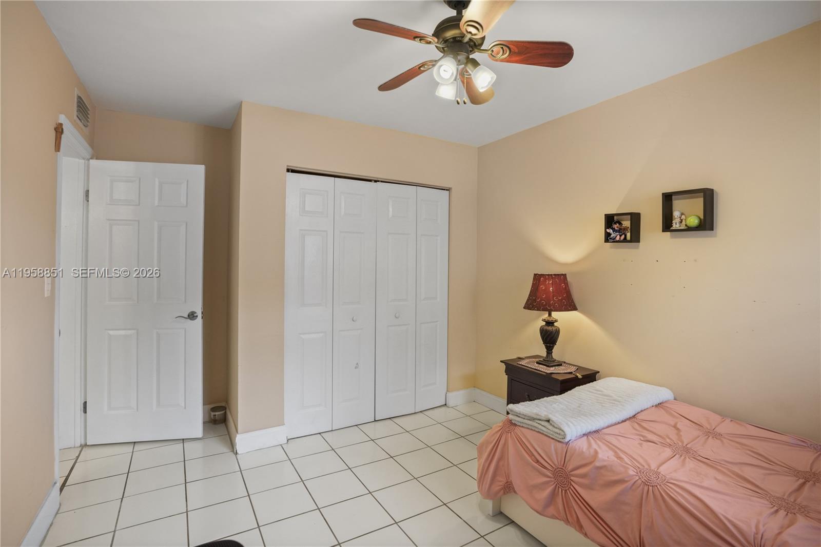 12930 Southwest 88th Terrace, Unit A104 Miami, FL 33186 - Photo 24 of 38 a bedroom with a bed and a chandelier
