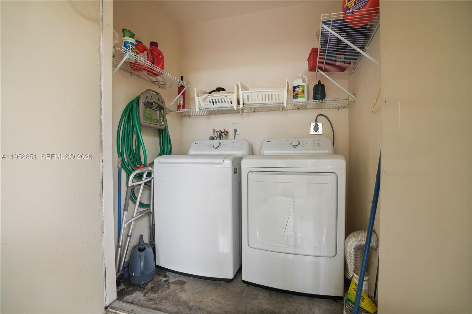 12930 Southwest 88th Terrace, Unit A104 Miami, FL 33186 - Photo 29 of 38 a utility room with dryer and washer
