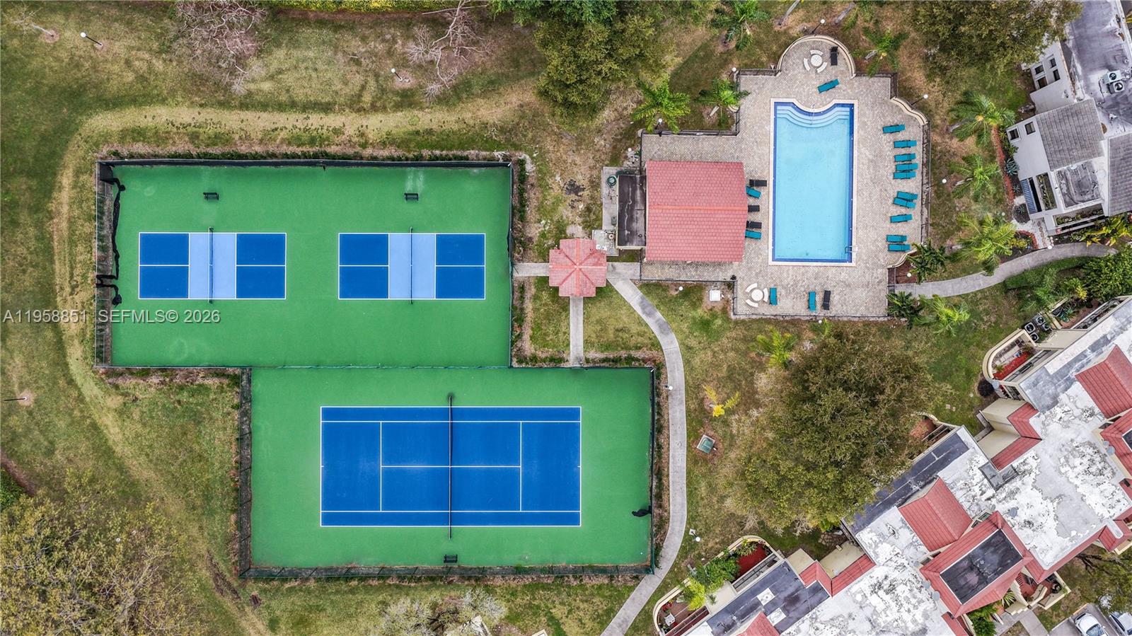 12930 Southwest 88th Terrace, Unit A104 Miami, FL 33186 - Photo 37 of 38 a view of a brick house with a small yard