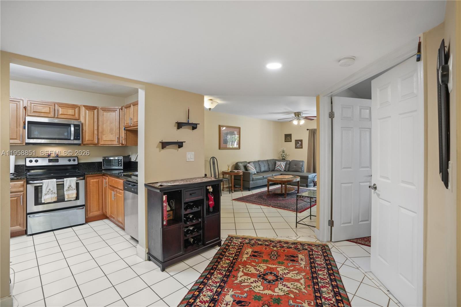 12930 Southwest 88th Terrace, Unit A104 Miami, FL 33186 - Photo 7 of 38 a kitchen with stainless steel appliances granite countertop a refrigerator and a stove top oven