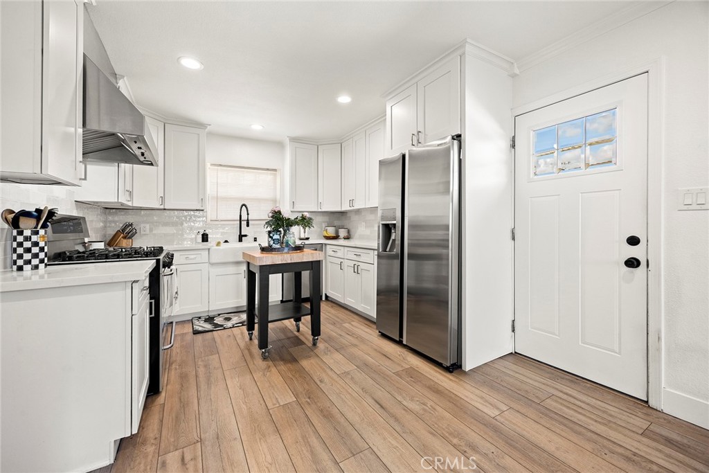 15914 West Road Whittier, CA 90603 - Photo 17 of 47 a kitchen with stainless steel appliances a refrigerator stove microwave and cabinets
