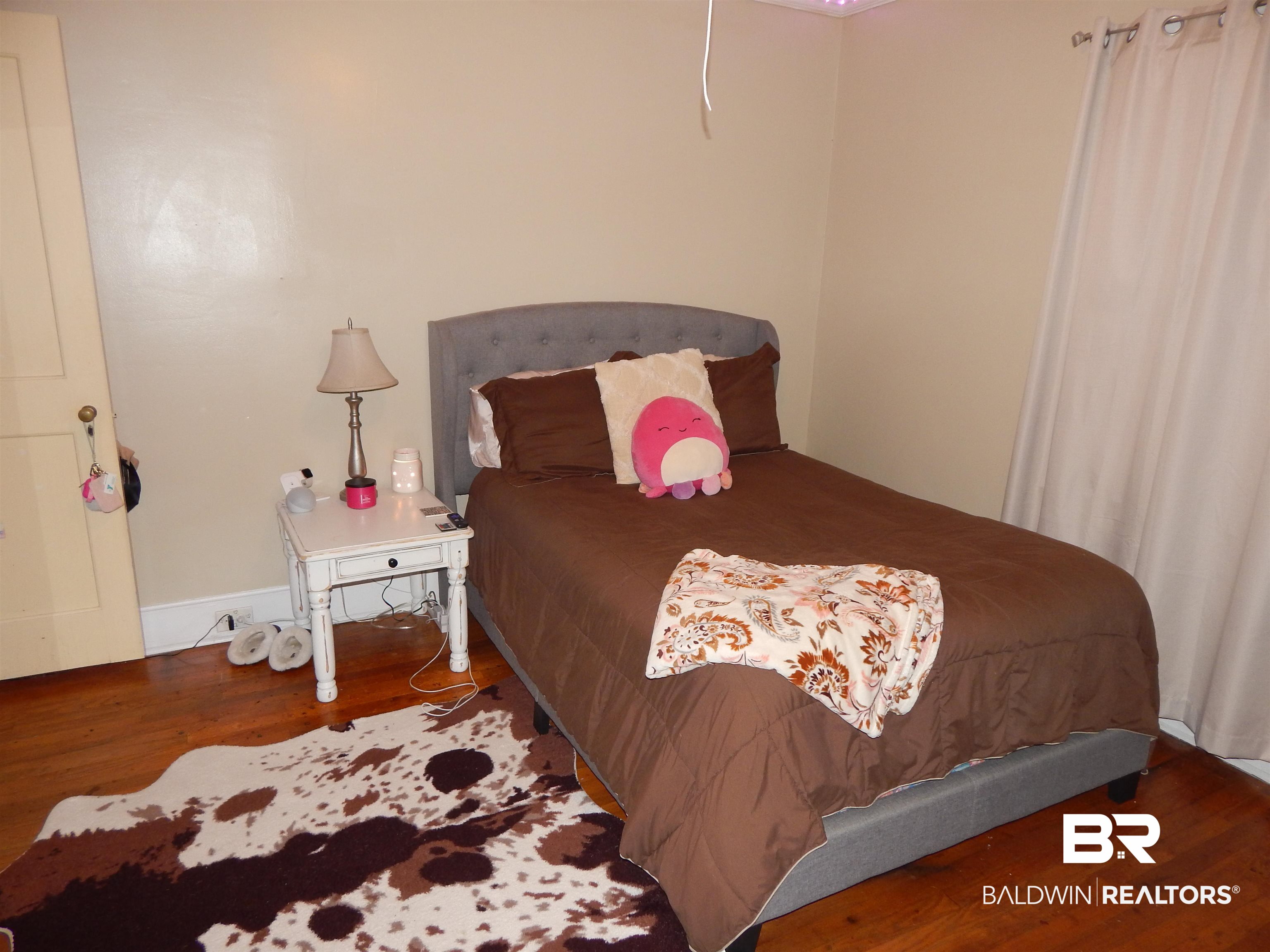 309 Bellview Avenue Evergreen, AL 36401 - Photo 16 of 27 Bedroom featuring wood finished floors and baseboards