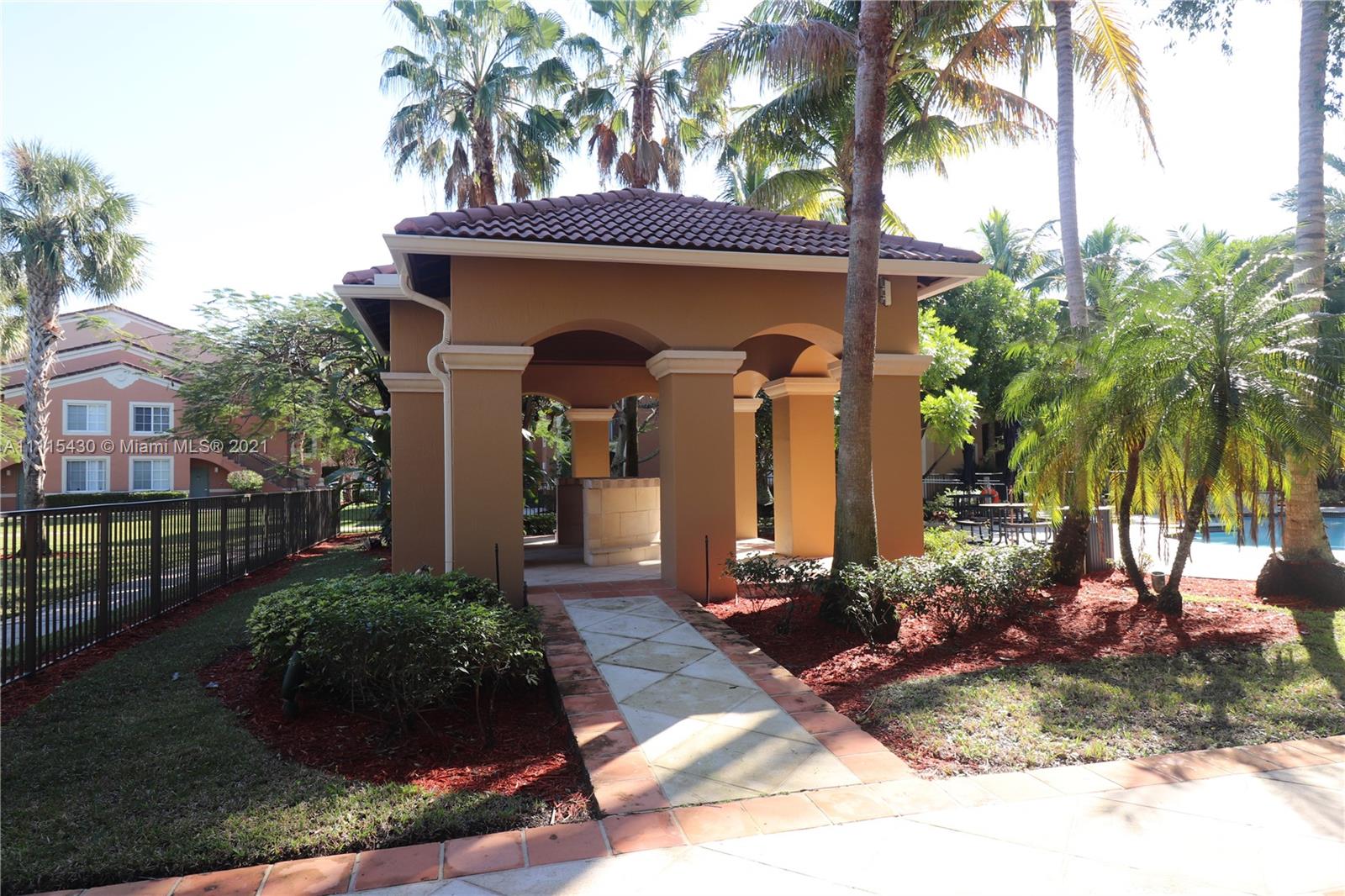 8020 North Nob Hill Road, Unit 208 Tamarac, FL 33321 - Photo 13 of 15 a front view of a house having yard