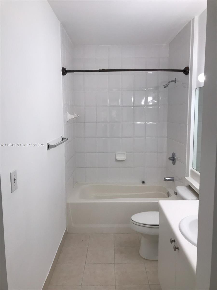 8020 North Nob Hill Road, Unit 208 Tamarac, FL 33321 - Photo 3 of 15 a bathroom with a toilet a sink and shower
