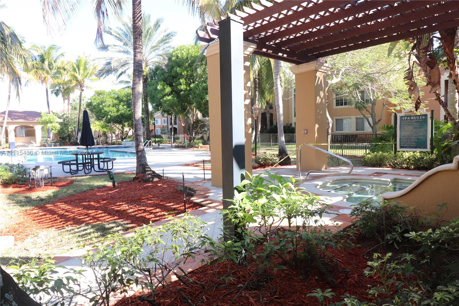 8020 North Nob Hill Road, Unit 208 Tamarac, FL 33321 - Photo 8 of 15 a view of a patio with table and chairs potted plants and large tree