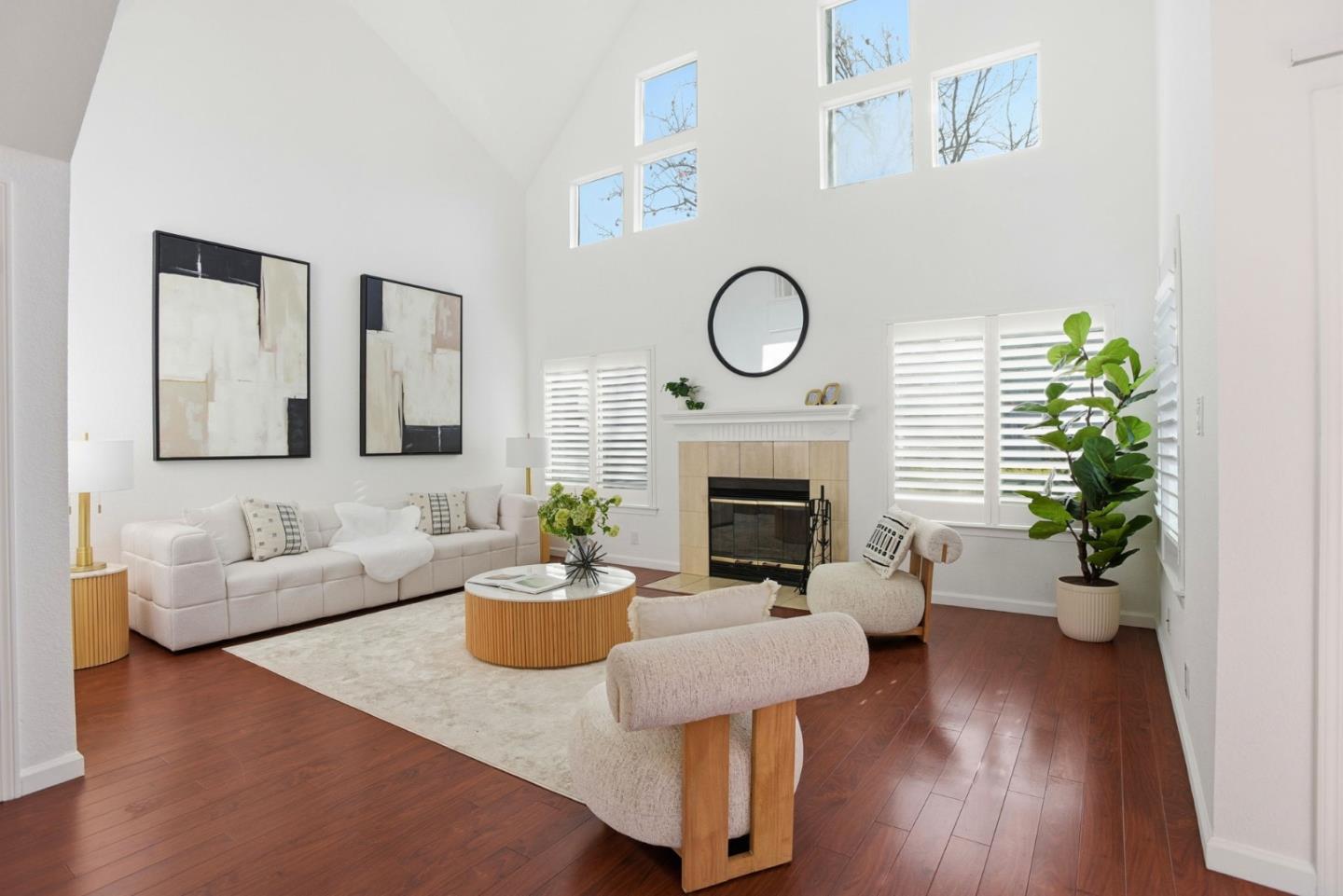 a living room with furniture potted plant and fireplace