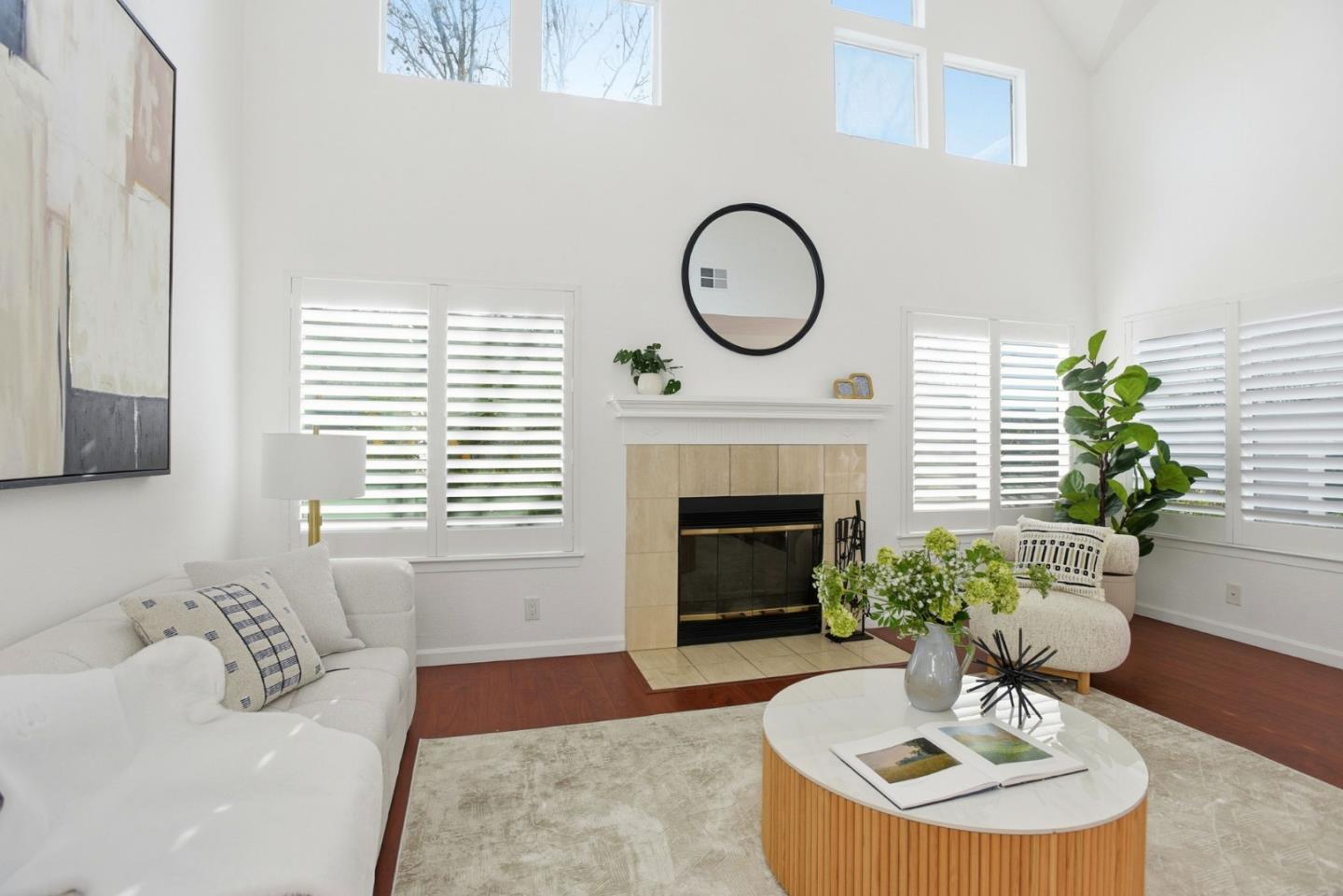 23 Dory Lane Foster City, CA 94404 - Photo 5 of 28 a living room with furniture a fireplace and a potted plant