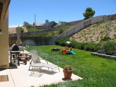 3248 Quarry Road Palmdale, CA 93550 - Photo 5 of 6 a view of a chair and tables in the garden