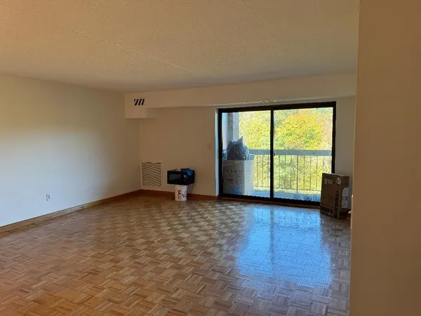 an empty room with large windows