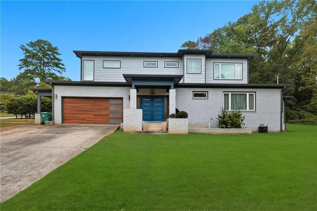 a front view of a house with a garden and plants