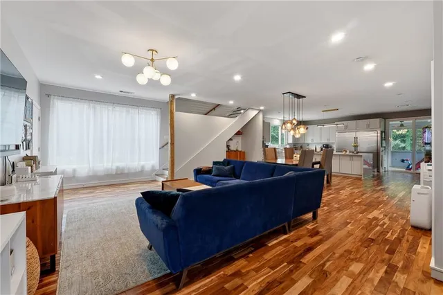 a living room with furniture and wooden floor
