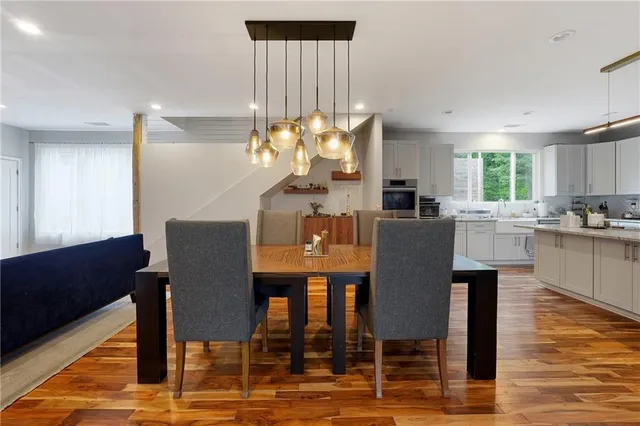 a view of a dining room with furniture and wooden floor