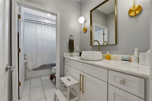 a bathroom with a granite countertop sink mirror and vanity