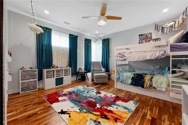 a bedroom with furniture and a wooden floor