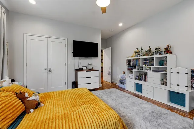 a bedroom with a bed and a flat screen tv