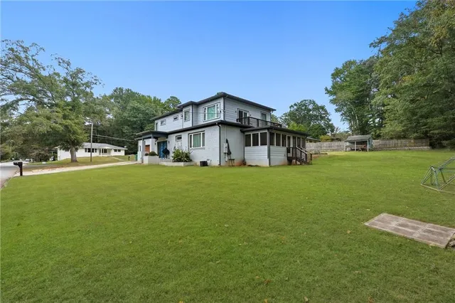 a front view of a house with a yard and trees