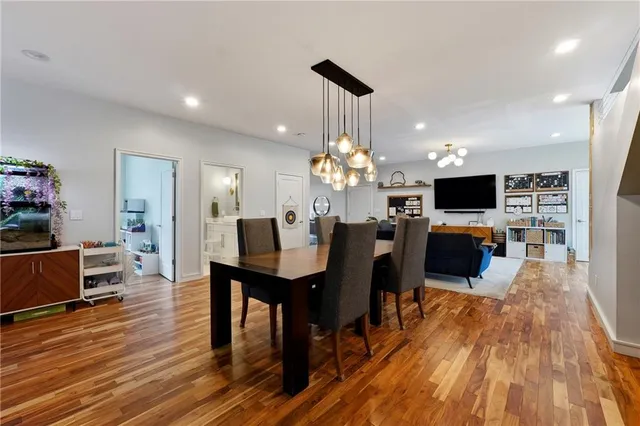 a view of a dining room with furniture a chandelier and wooden floor