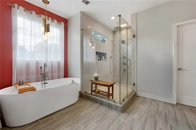 a bathroom with a tub and shower