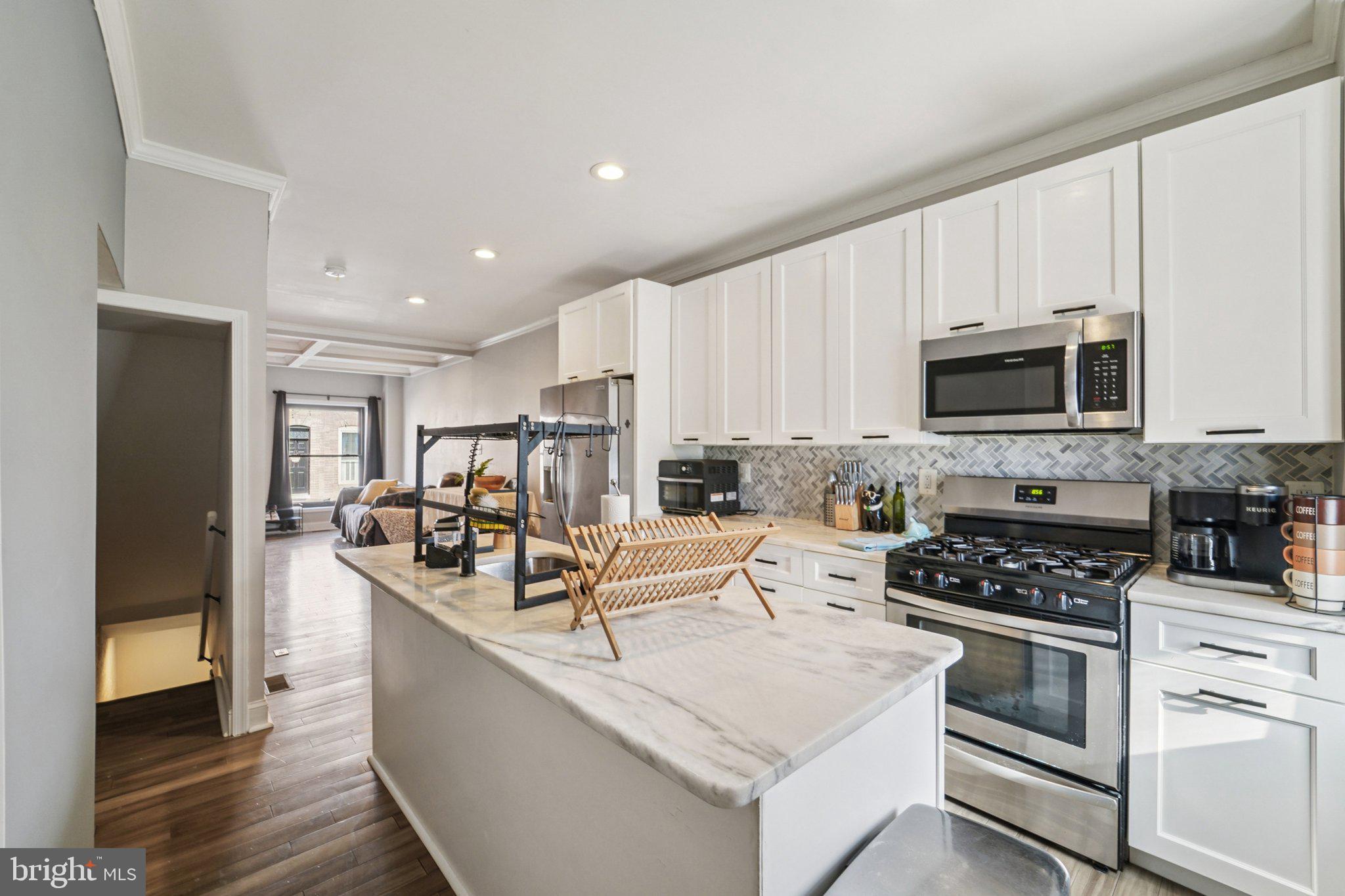 147 North Streeper Street Baltimore, MD 21224 - Photo 11 of 34 a kitchen with white cabinets and appliances