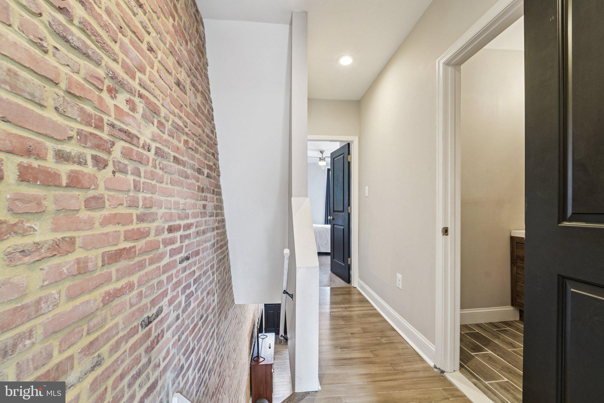 147 North Streeper Street Baltimore, MD 21224 - Photo 16 of 34 a view of a hallway with wooden floor and staircase