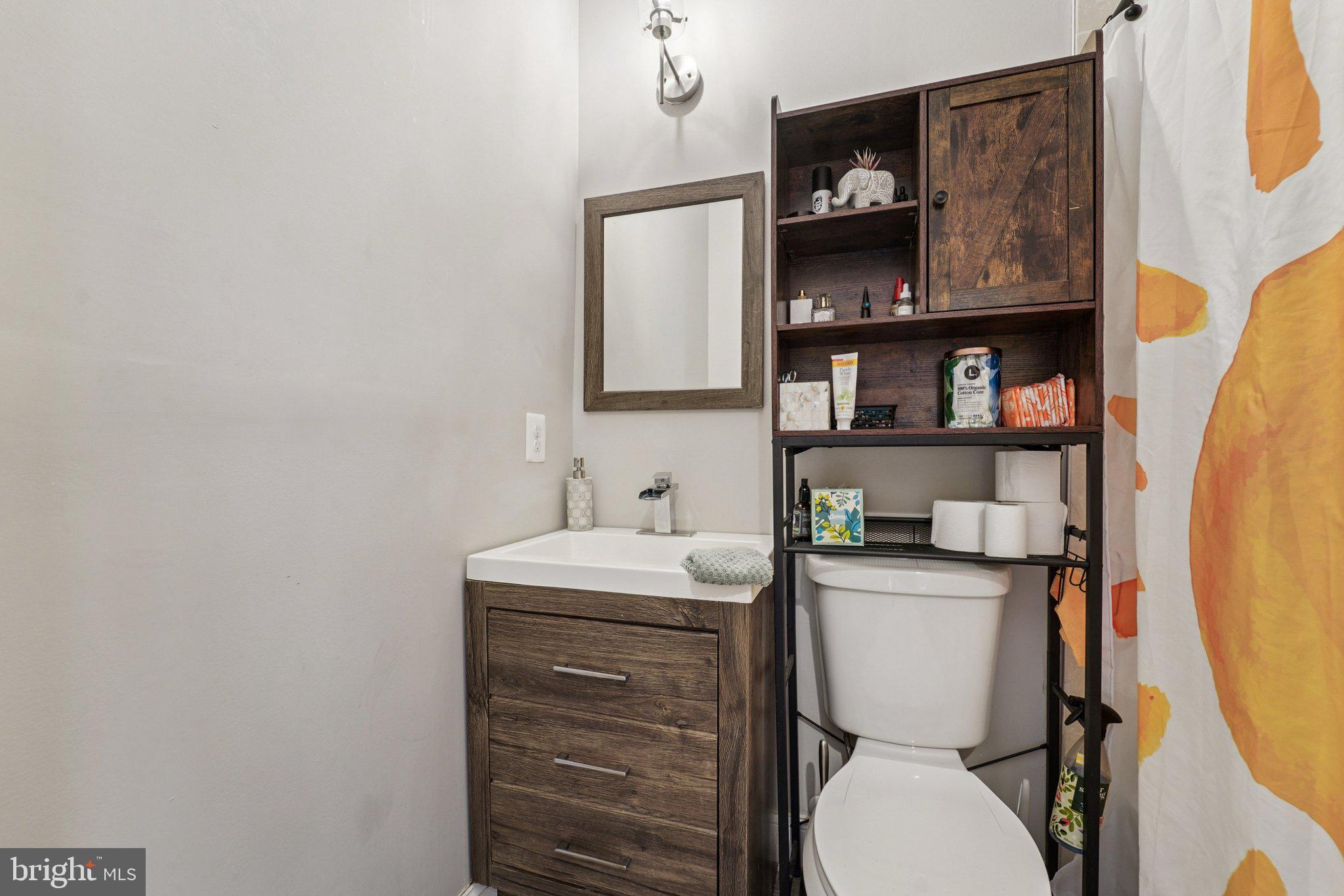 147 North Streeper Street Baltimore, MD 21224 - Photo 19 of 34 a bathroom with a toilet sink and mirror