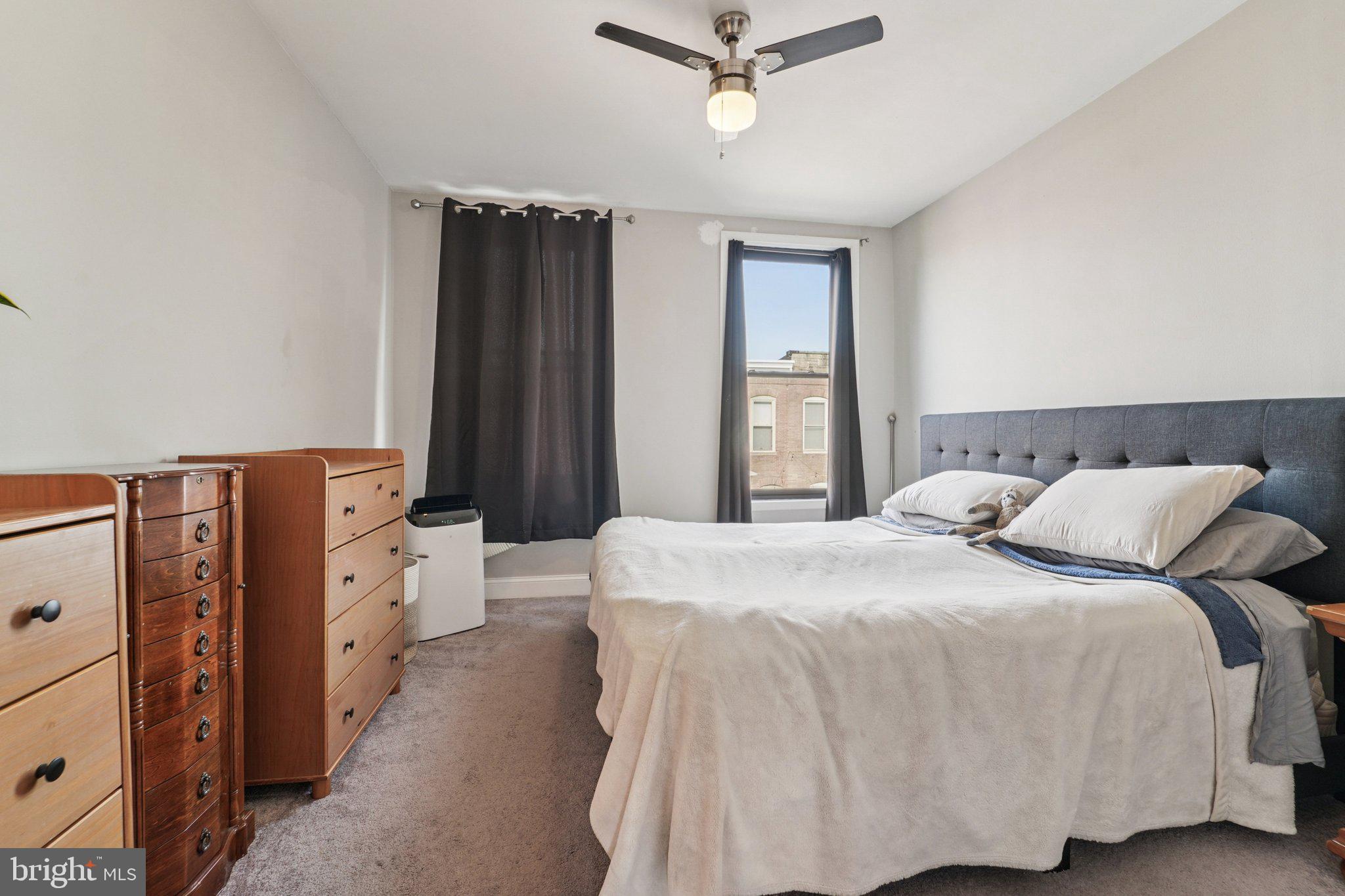 147 North Streeper Street Baltimore, MD 21224 - Photo 20 of 34 a bedroom with a bed and a chandelier