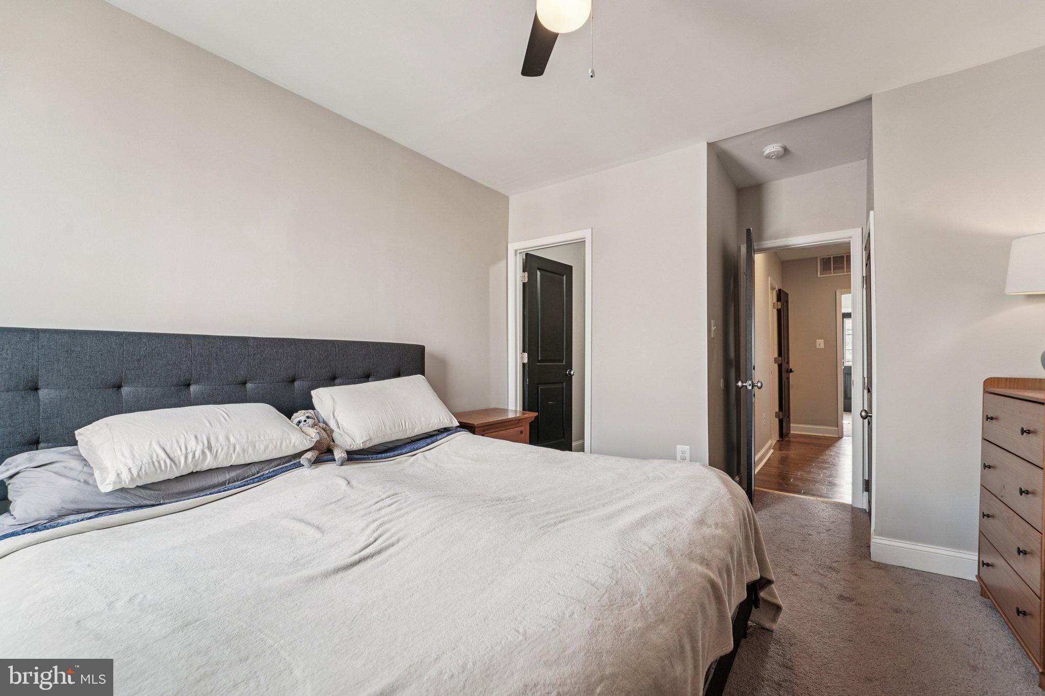147 North Streeper Street Baltimore, MD 21224 - Photo 21 of 34 a bedroom with double bed and a night stand