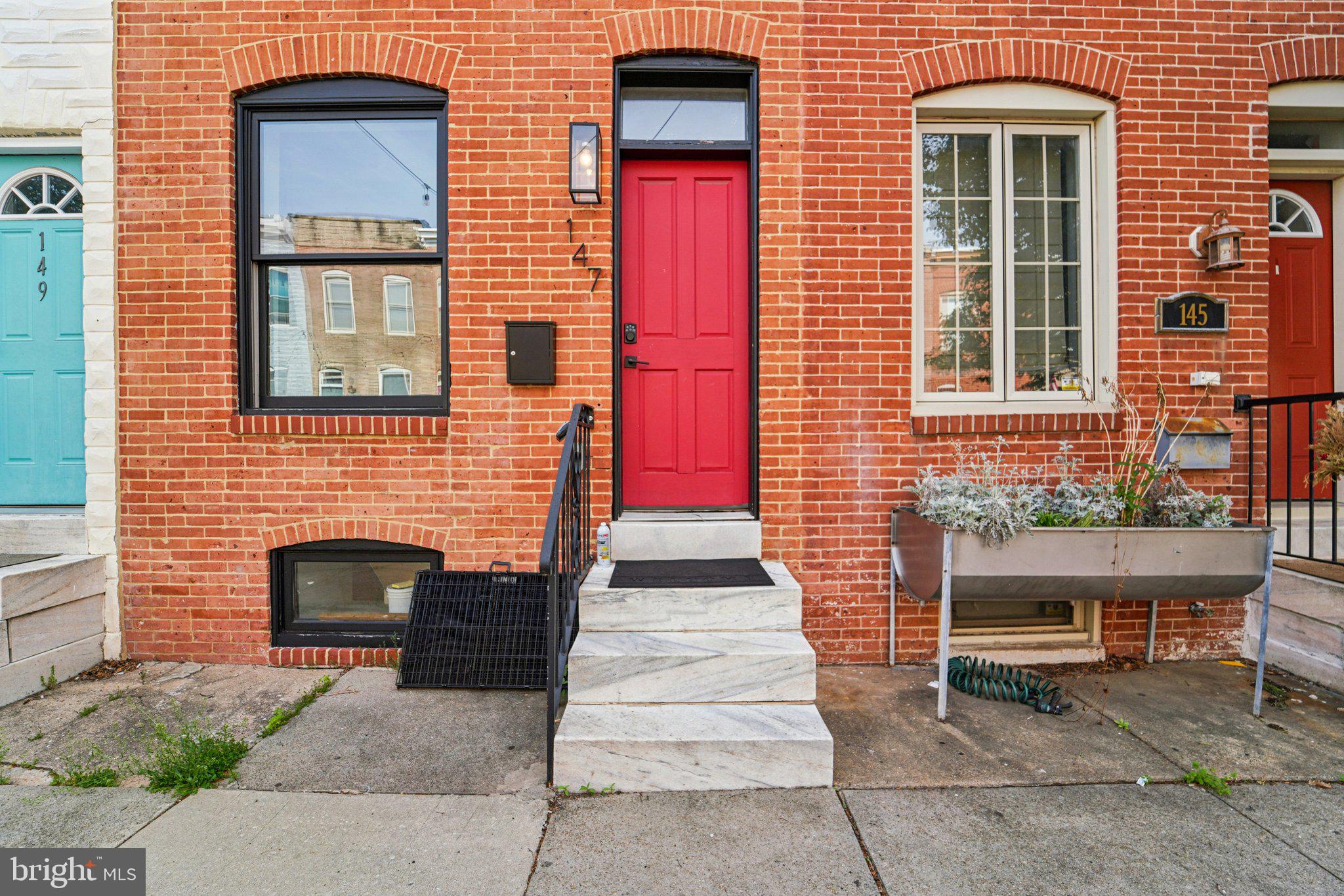 147 North Streeper Street Baltimore, MD 21224 - Photo 5 of 34 a front view of a house with a yard and garage
