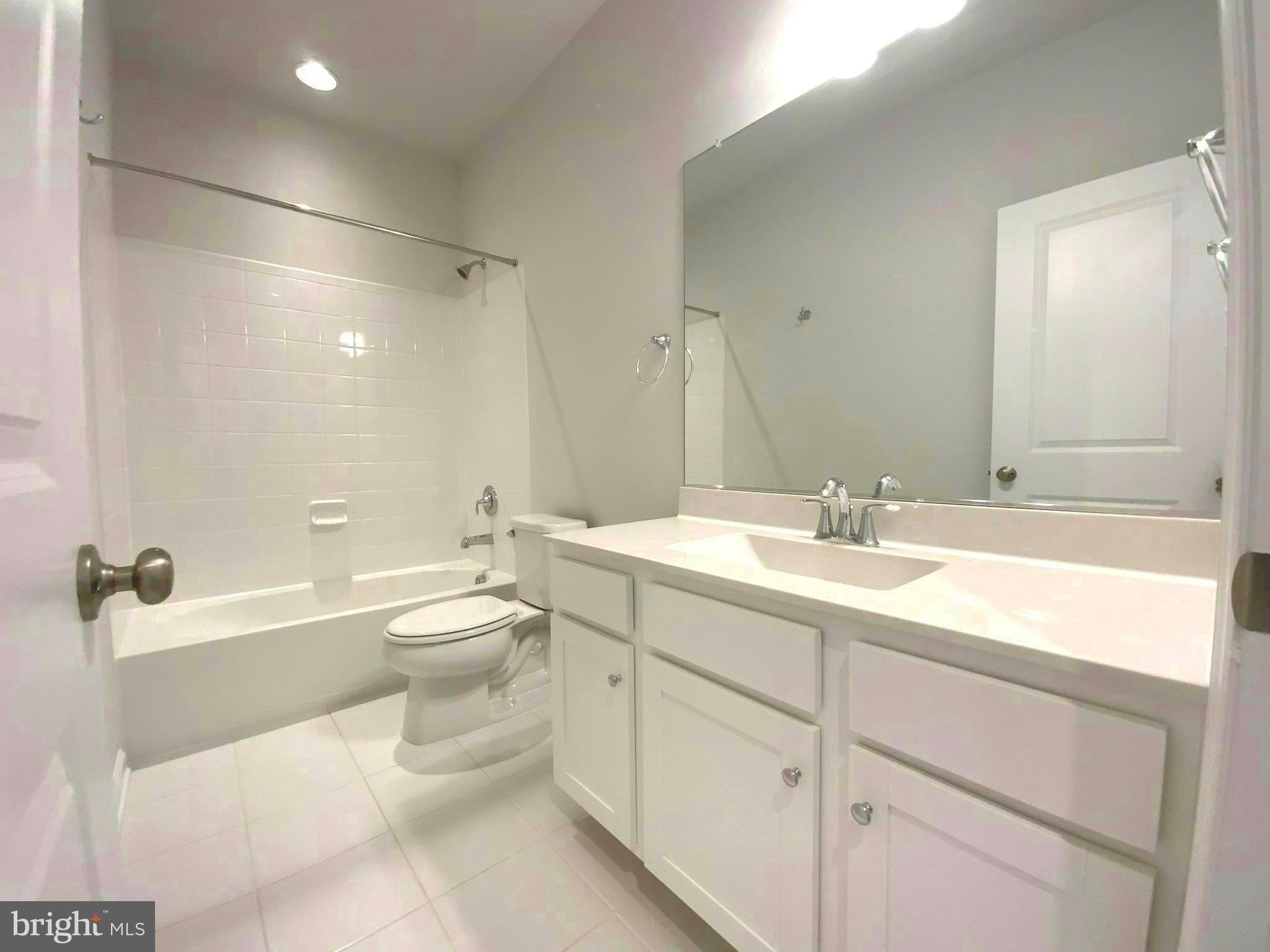 5763 Hawk Ridge Road Frederick, MD 21704 - Photo 26 of 73 a bathroom with a toilet a sink a tub and mirror