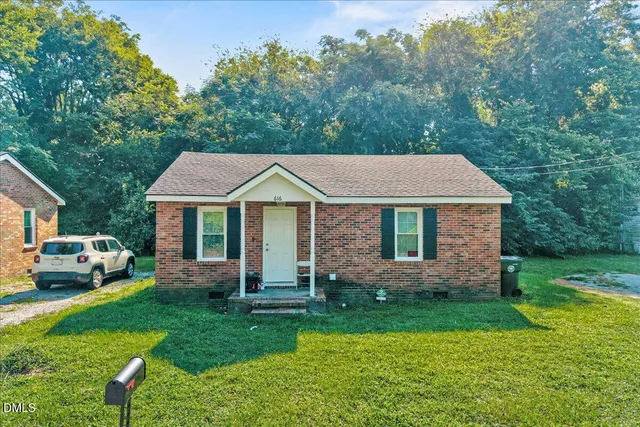 a aerial view of a house with a yard table and chairs